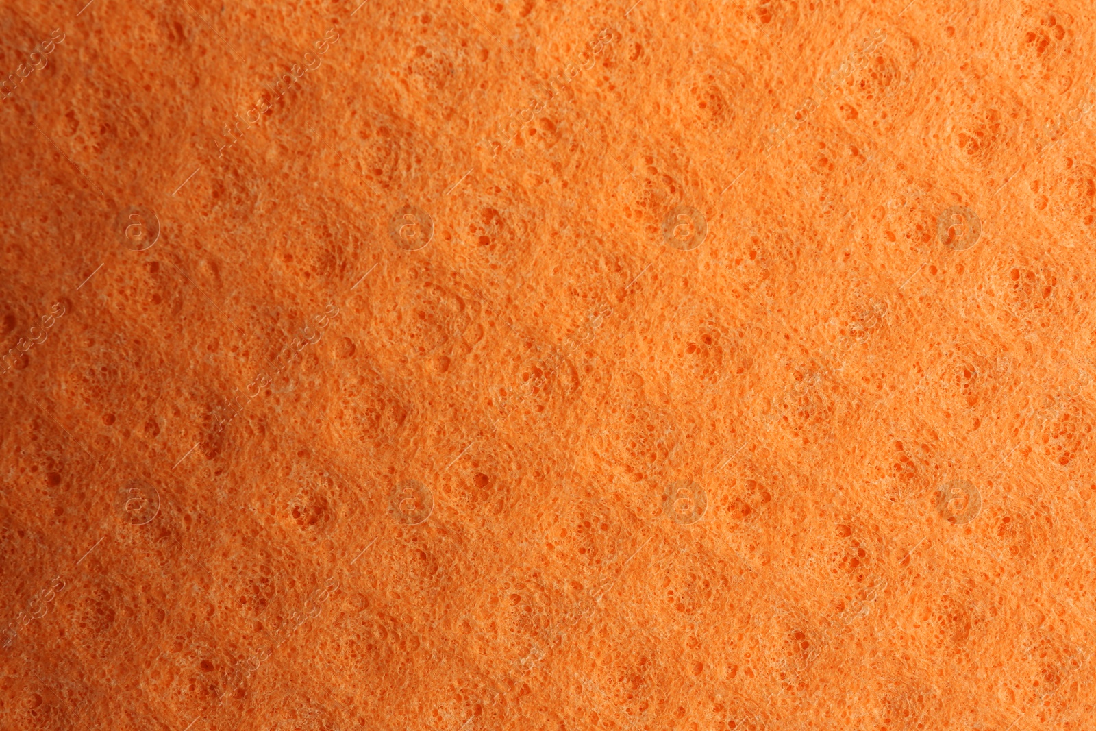 Photo of Orange foam rubber as background, top view