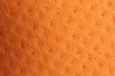 Photo of Orange foam rubber as background, top view