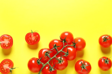 Photo of Flat lay composition with ripe cherry tomatoes on color background. Space for text