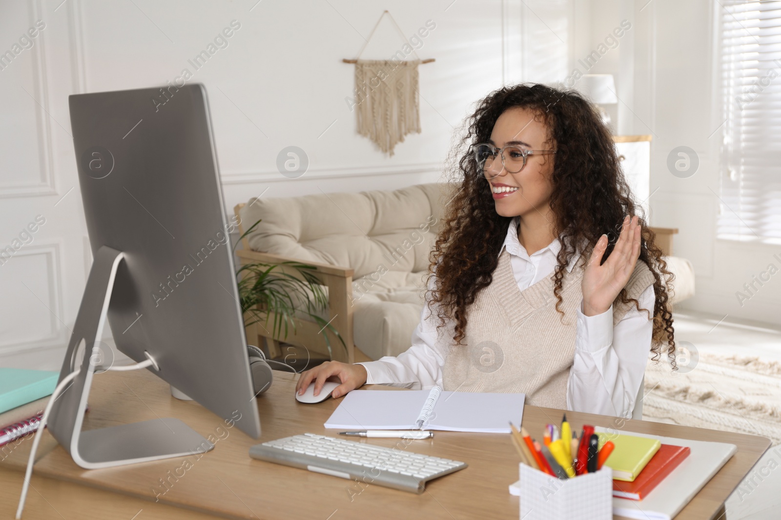 Photo of African American woman using video chat while studying at home. Distance learning