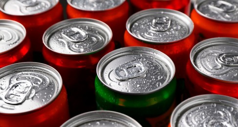 Photo of Energy drink in wet cans, closeup. Functional beverage