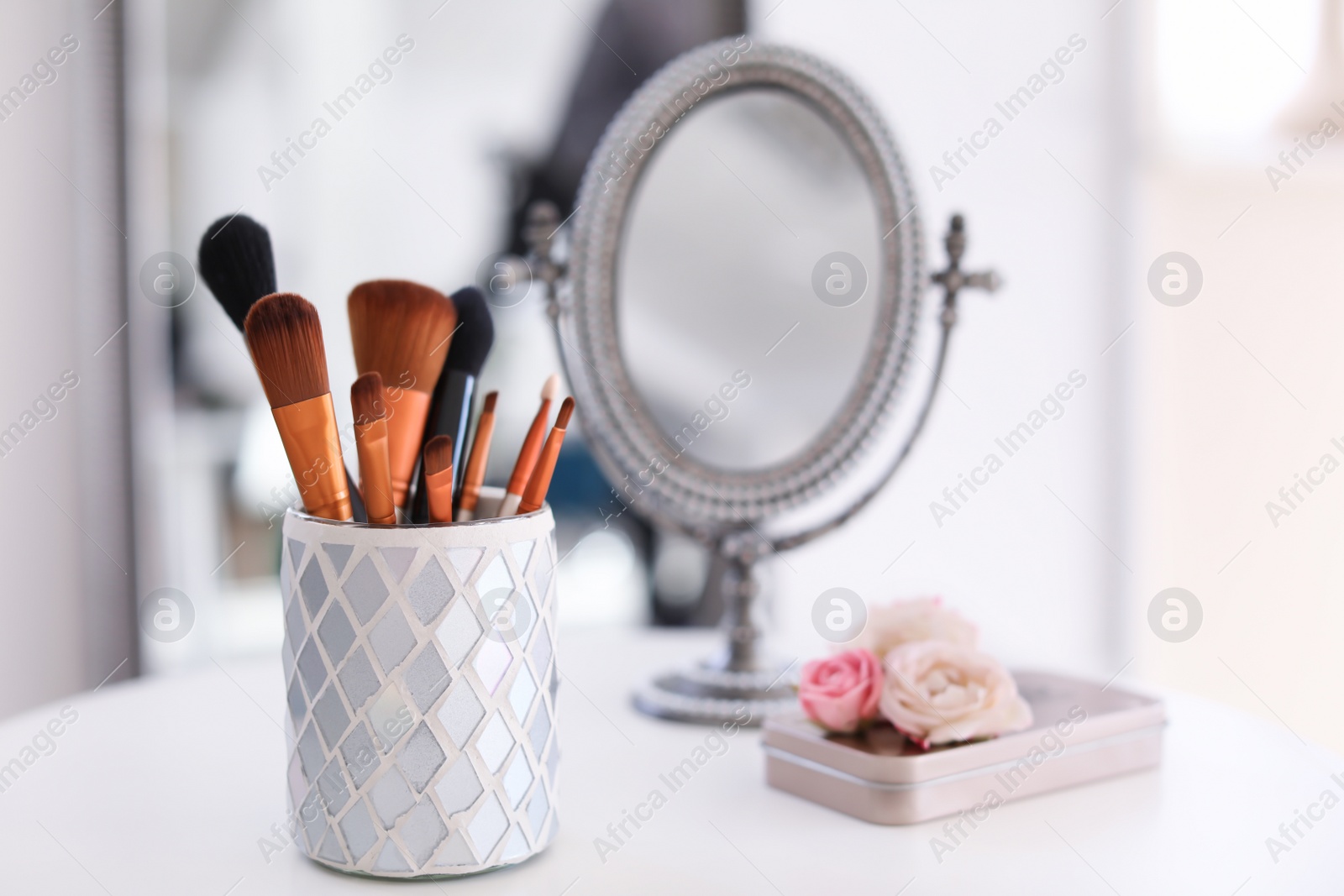 Photo of Holder with makeup brushes on table