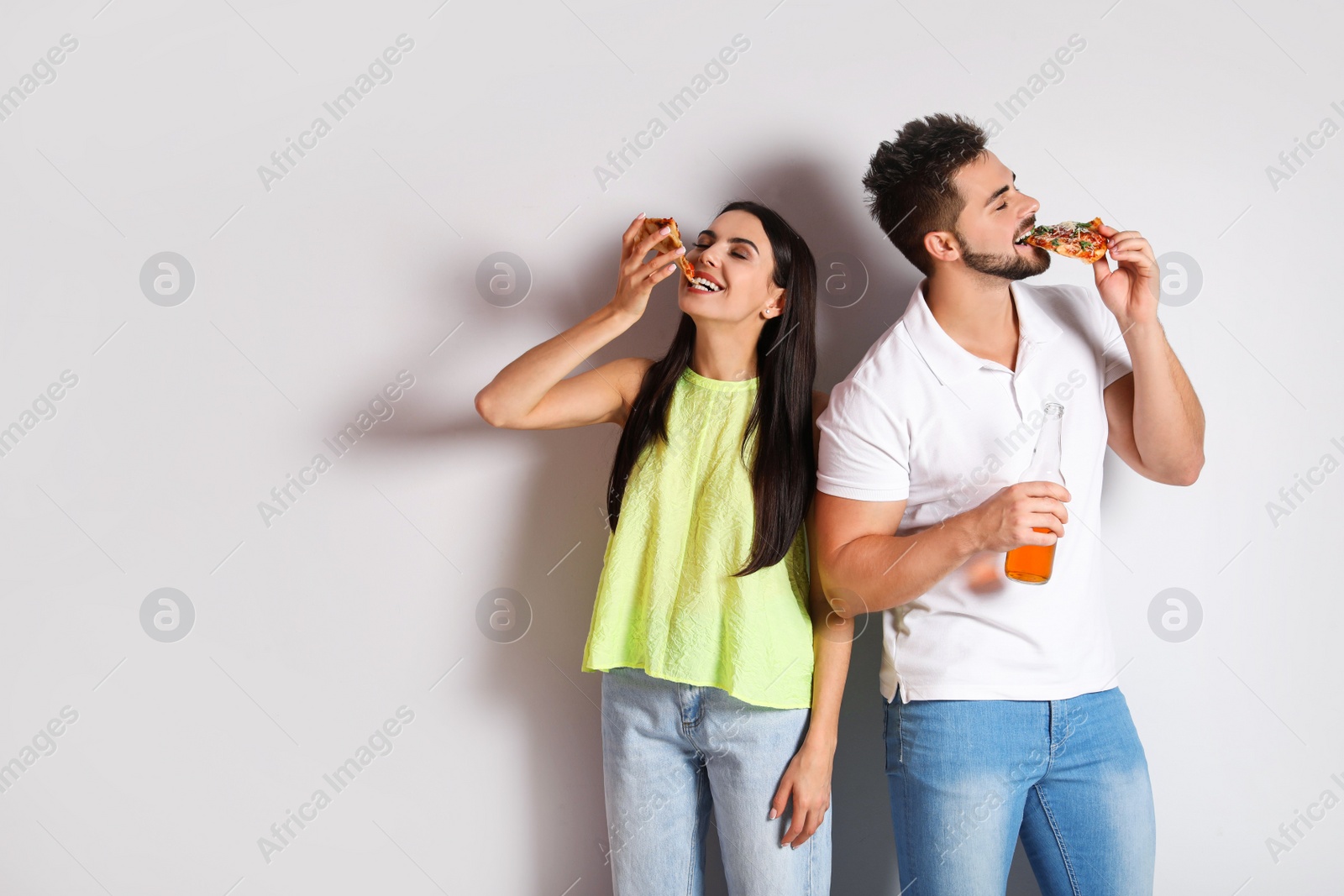 Photo of Happy couple with pizza and beer on white background, space for text