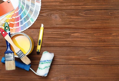 Set of decorator's tools on wooden background, flat lay