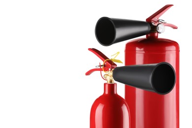 Photo of Red fire extinguishers on white background, space for text