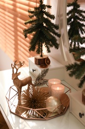 Photo of Composition with decorative reindeer and Christmas trees on dressing table