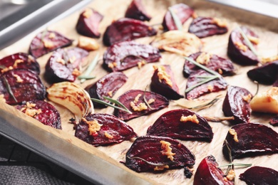 Roasted beetroot slices in baking dish, closeup