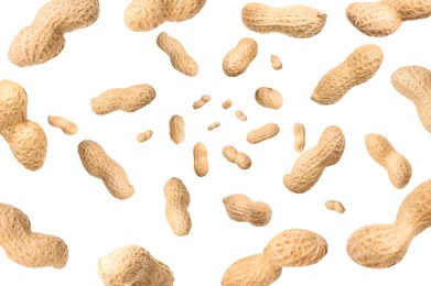 Image of Unpeeled peanuts in air on white background