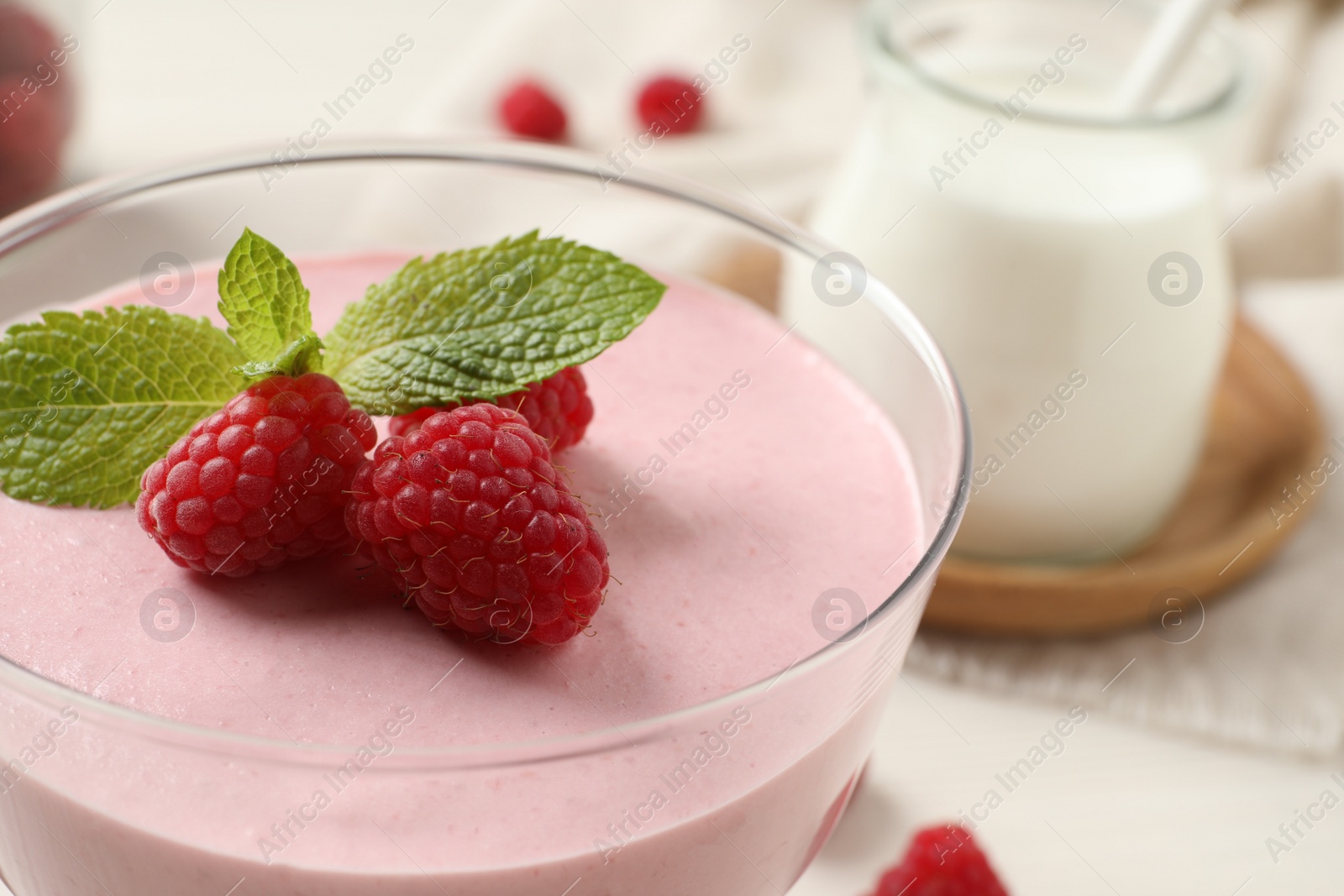 Photo of Glass of delicious raspberry mousse with mint, closeup