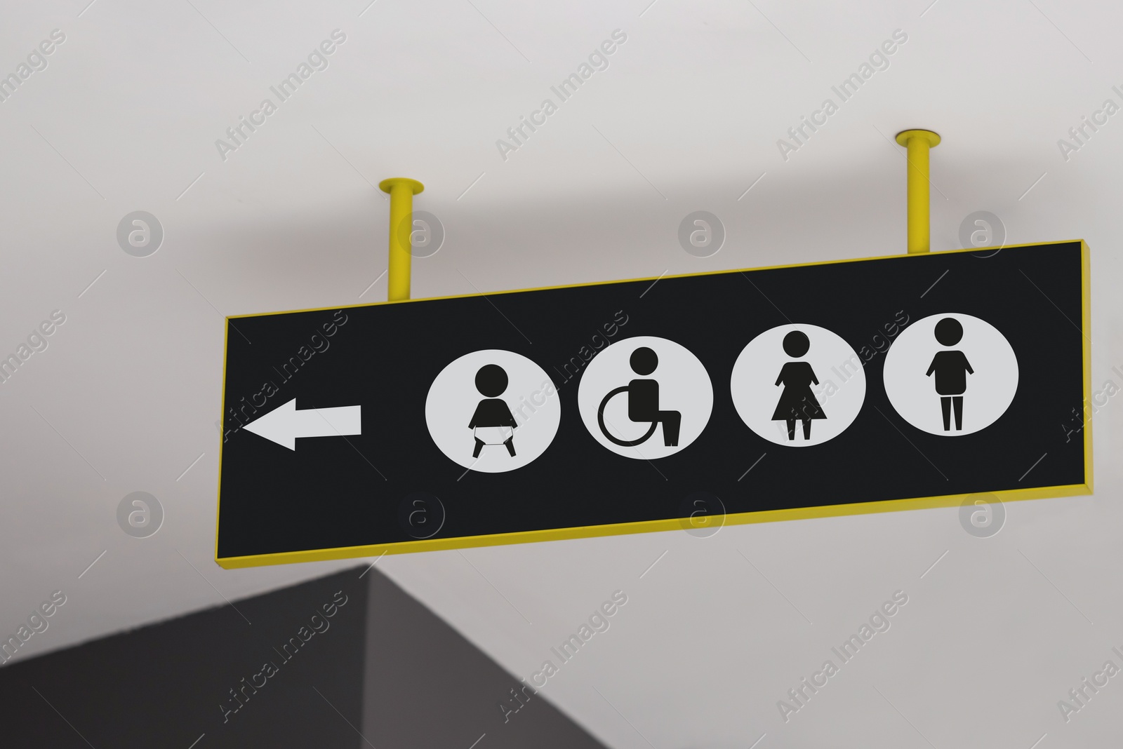 Image of Public toilet sign with symbols and arrow showing direction