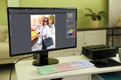 Image of Designer's workplace. Computer with photo editor application on table indoors