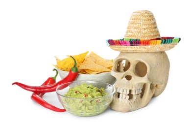 Photo of Mexican sombrero hat, human scull, chili peppers, nachos chips and guacamole in bowls isolated on white