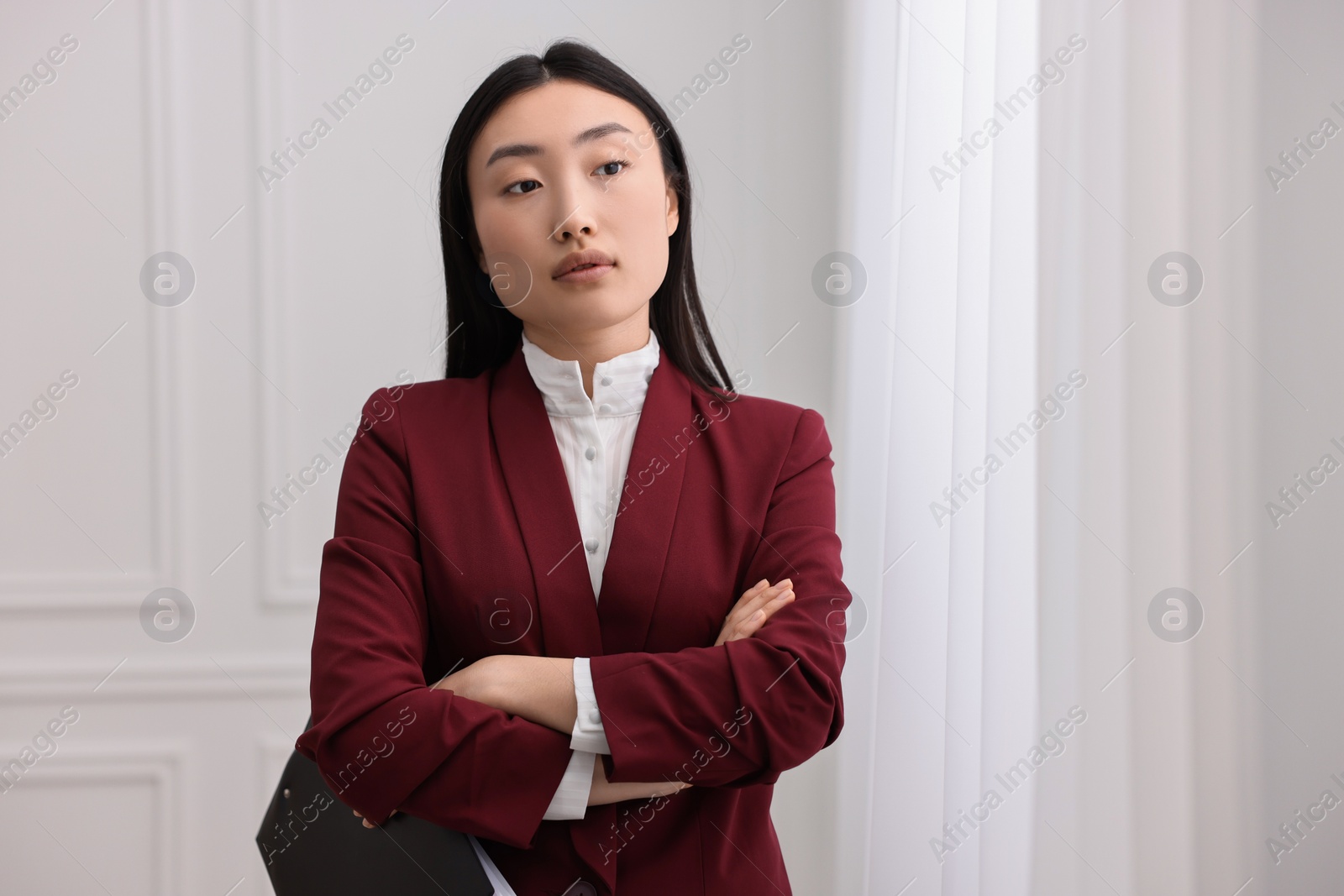 Photo of Portrait of notary with crossed arms in office