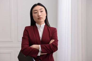 Photo of Portrait of notary with crossed arms in office