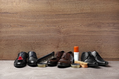 Footwear and shoe shine kit on grey surface, space for text