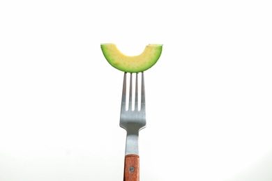 Photo of Fork with slice of avocado on white background