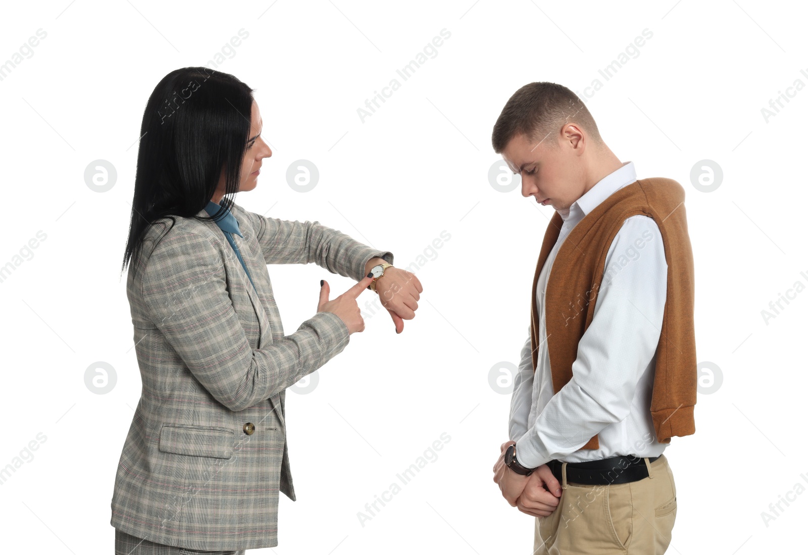 Photo of Businesswoman pointing on wrist watch while scolding employee for being late against white background