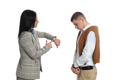 Photo of Businesswoman pointing on wrist watch while scolding employee for being late against white background