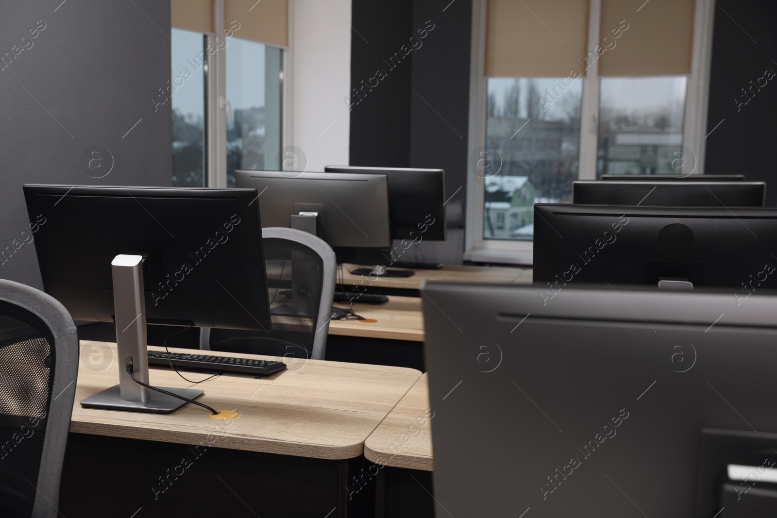 Photo of Many modern computers in open space office