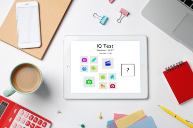 Image of Modern tablet with IQ test on white table, flat lay 