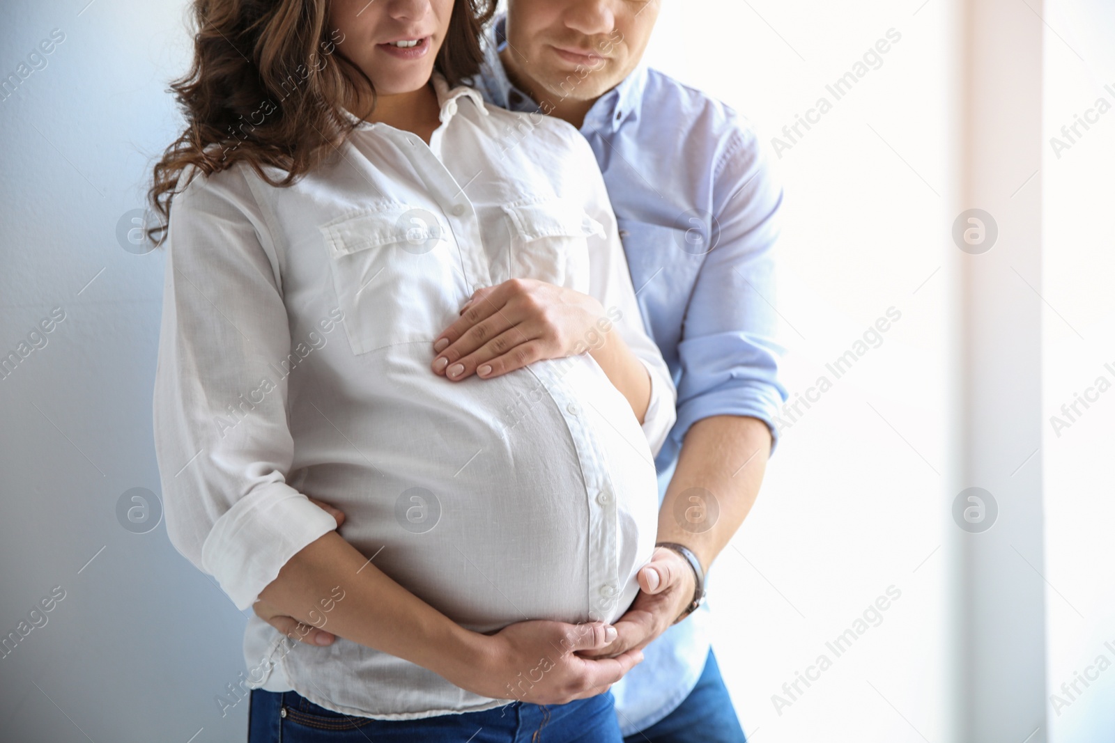 Photo of Pregnant woman with her husband on white background. Space for text