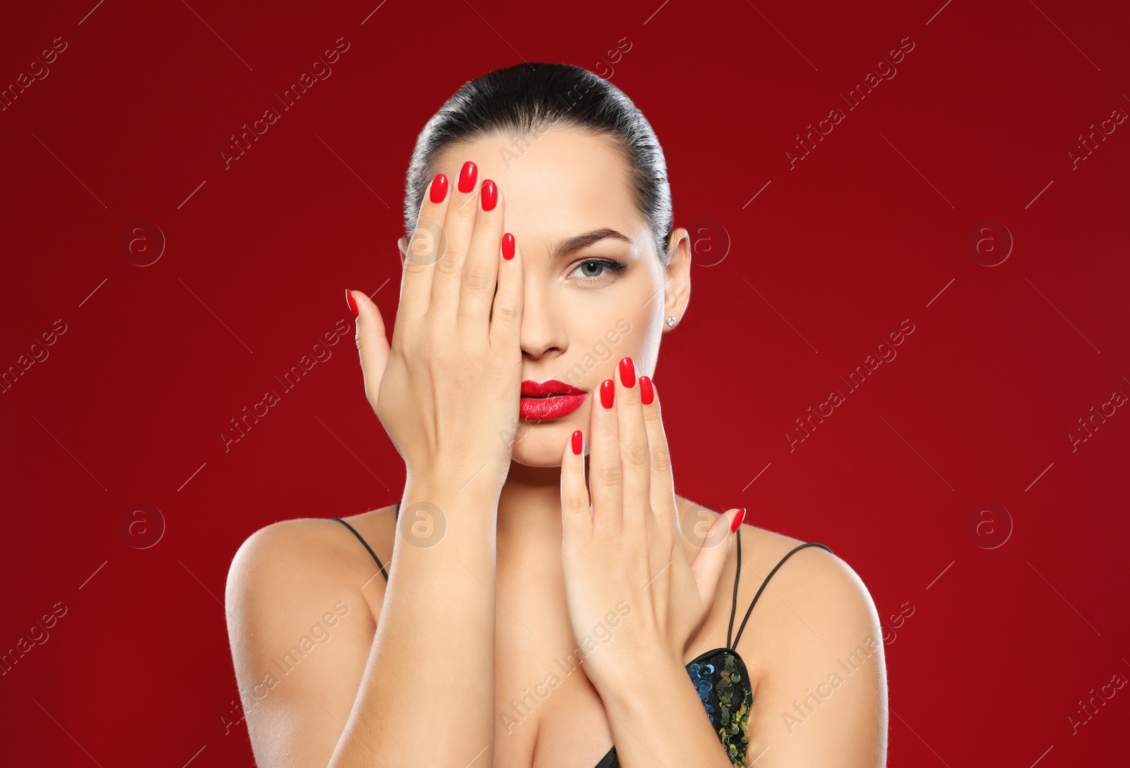 Photo of Portrait of beautiful young woman with bright manicure on color background. Nail polish trends