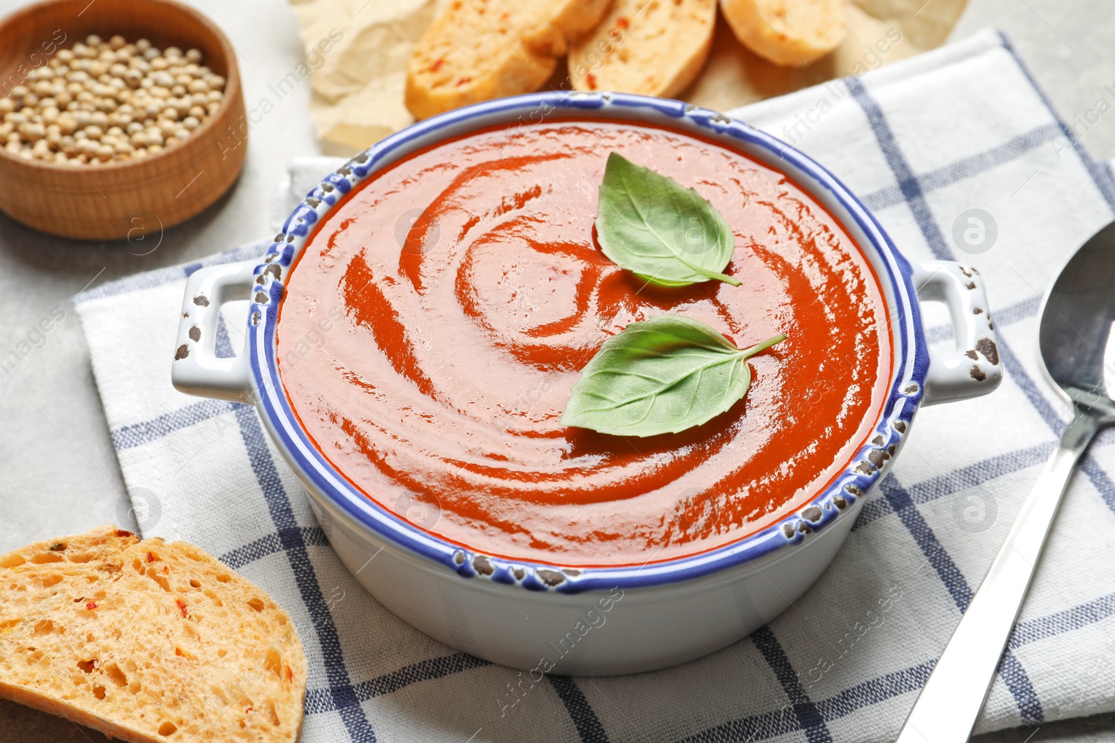 Photo of Dish with delicious fresh homemade tomato soup on table