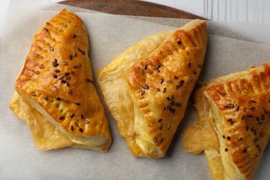 Fresh delicious puff pastry on parchment, top view