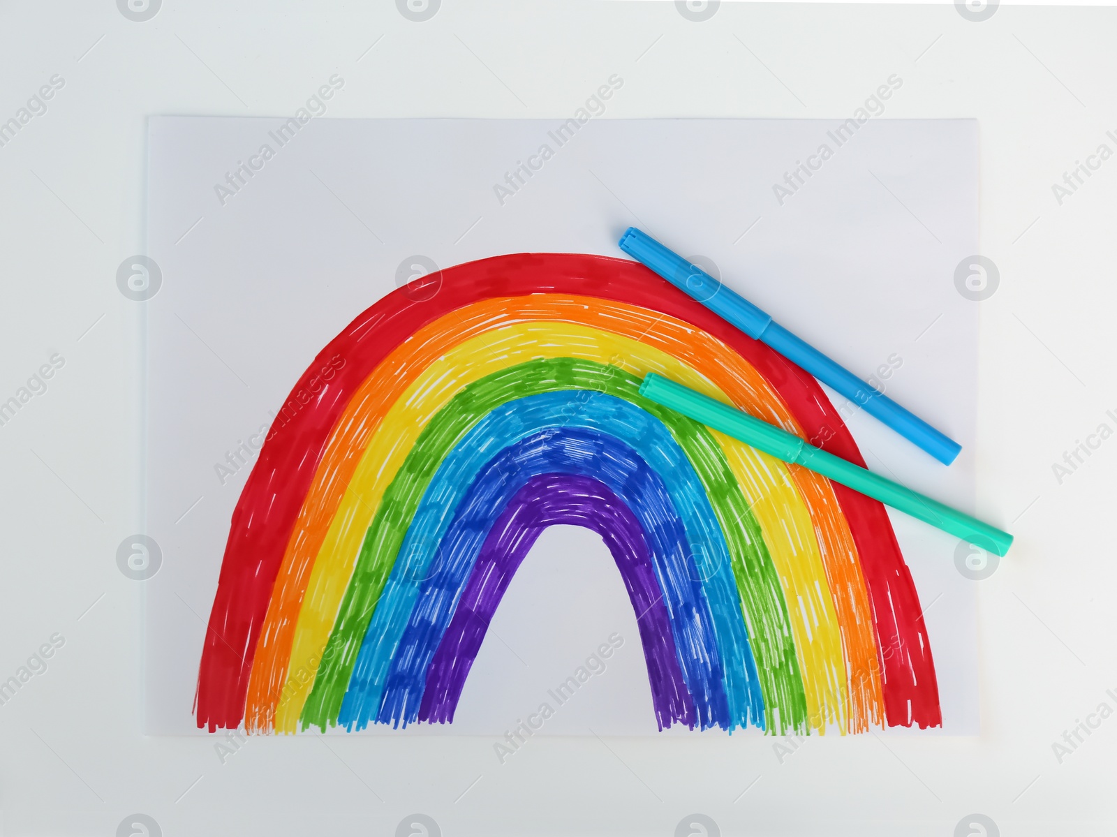Photo of Painting of rainbow and markers on white background, flat lay. Stay at home concept