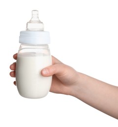 Woman holding feeding bottle with infant formula on white background, closeup