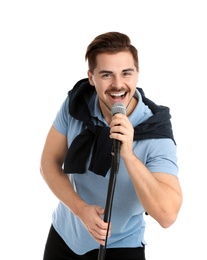 Young handsome man in casual clothes singing with microphone on white background