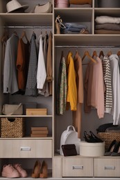 Photo of Wardrobe closet with different stylish clothes, accessories and shoes