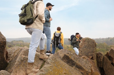 Photo of Group of hikers with backpacks at top of mountain