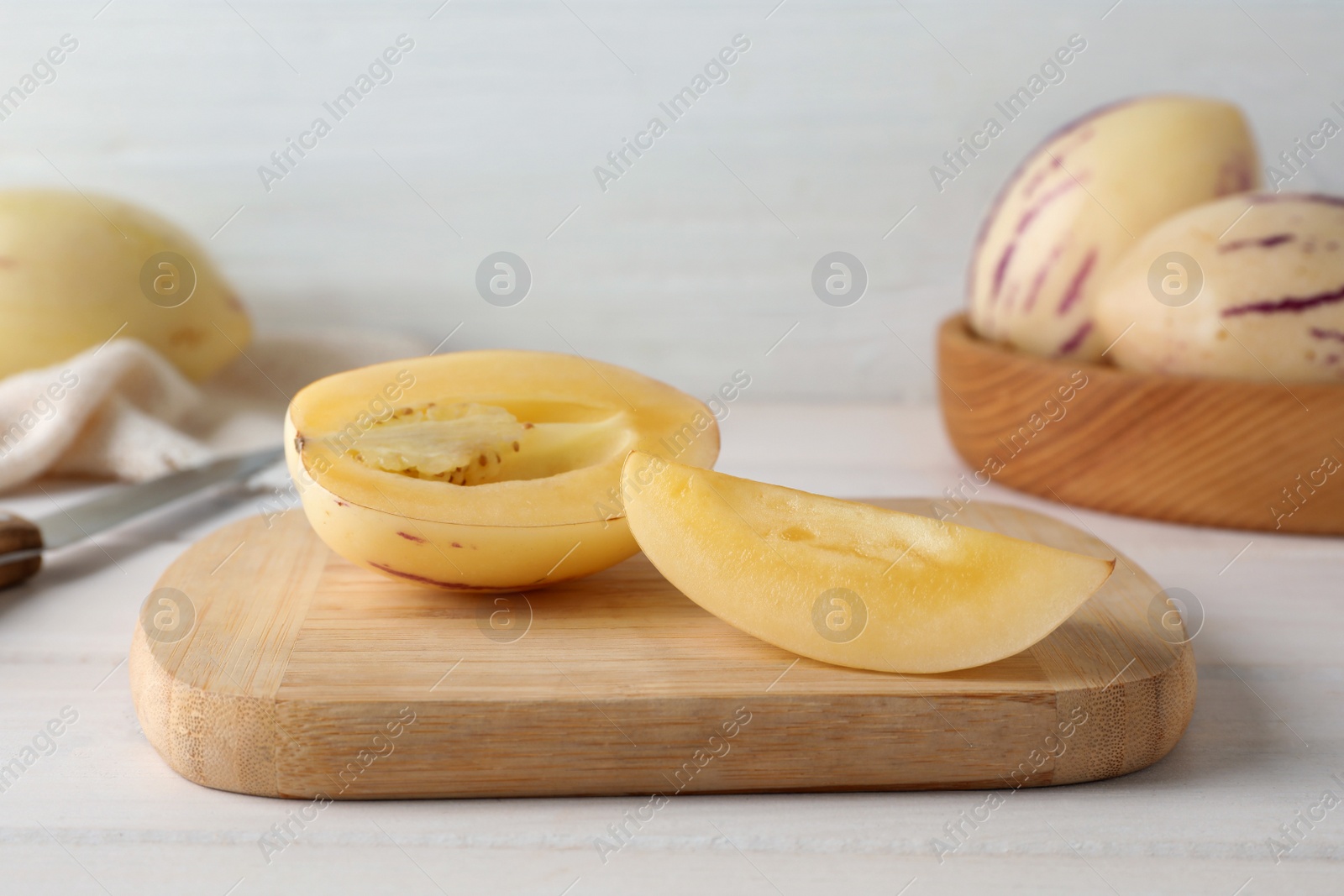Photo of Cut pepino melon on white wooden table