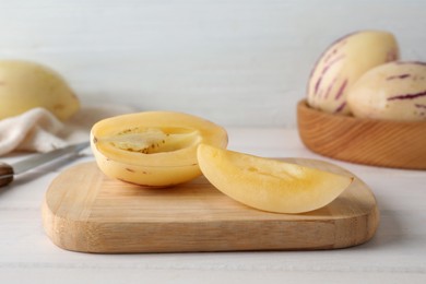 Cut pepino melon on white wooden table