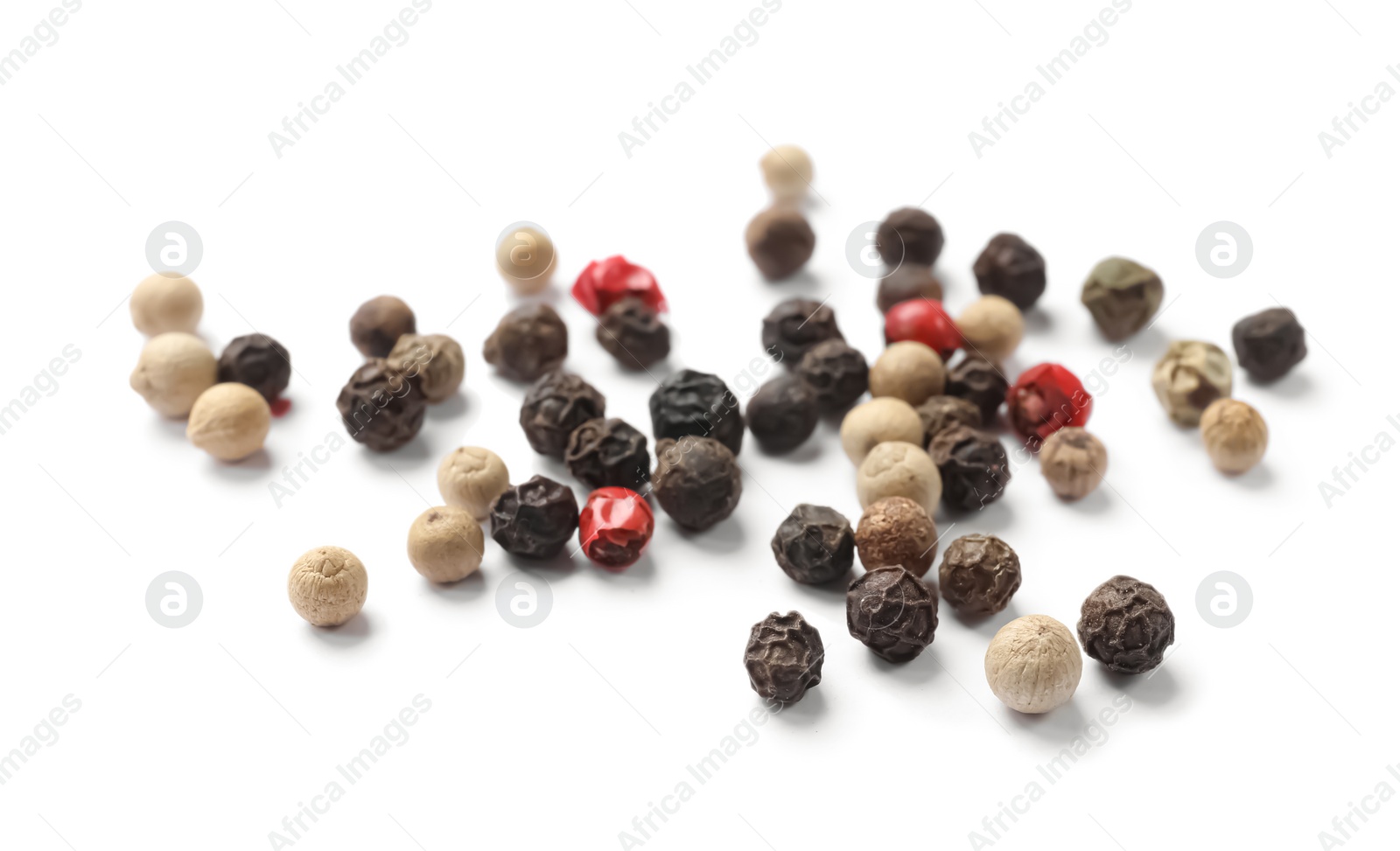 Photo of Aromatic spices. Pile of different peppers isolated on white