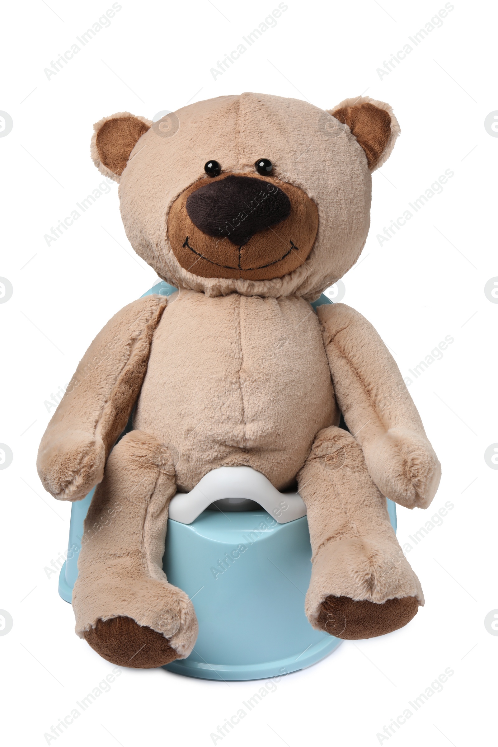 Photo of Teddy bear on light blue baby potty isolated on white. Toilet training