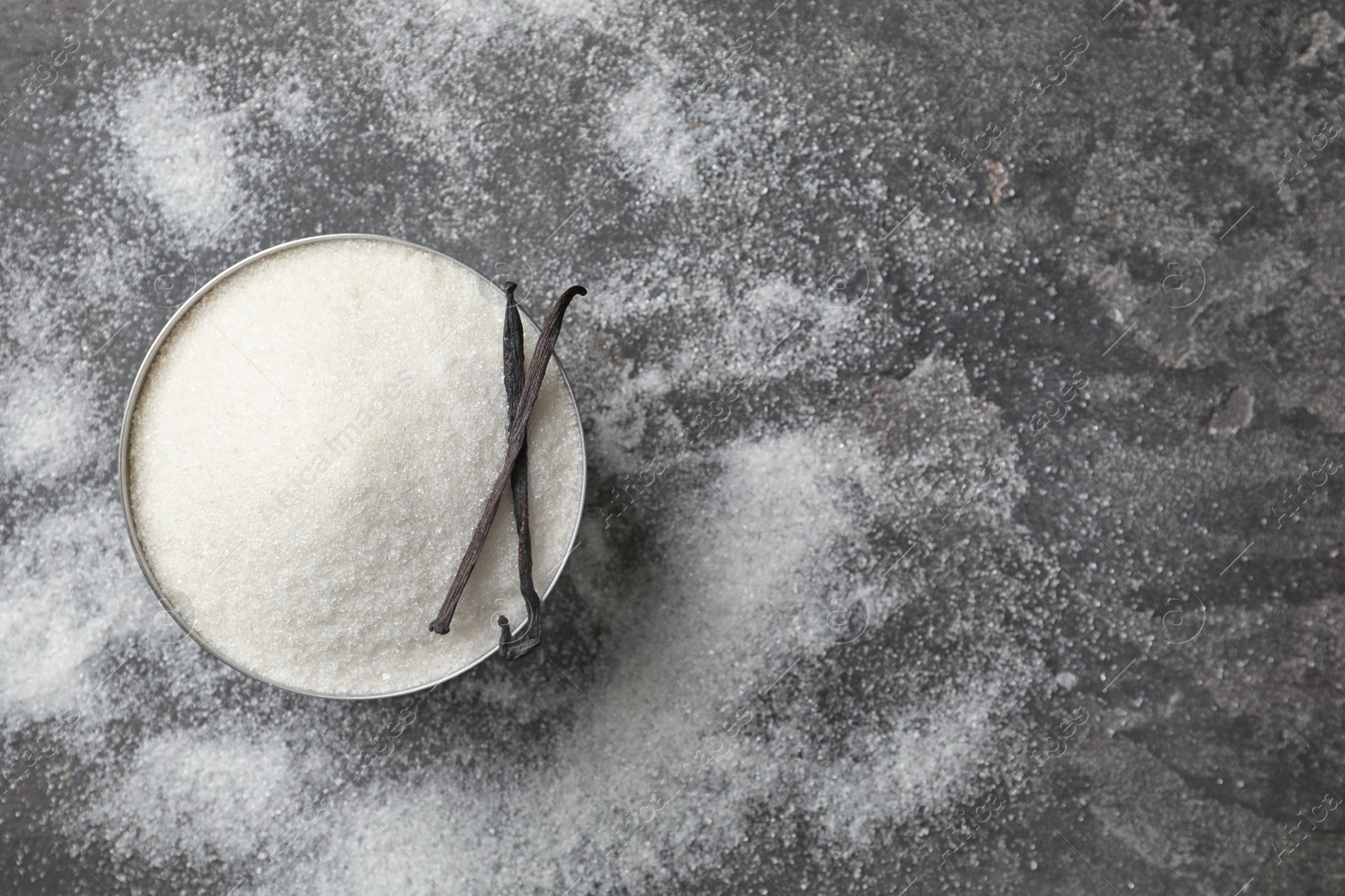 Photo of Bowl with vanilla sugar on grey background, top view