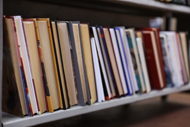Photo of Collection of books on metal shelf in library