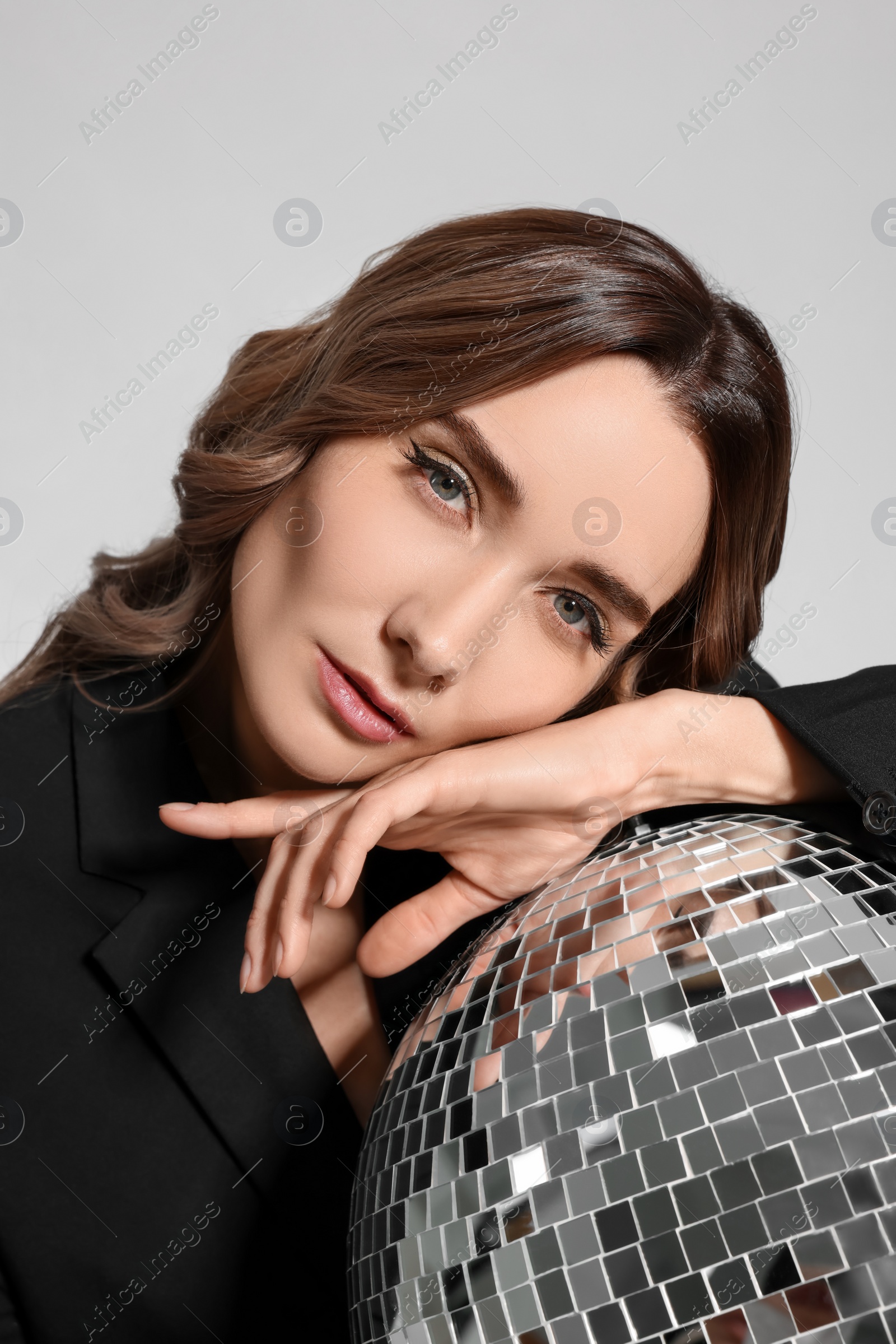 Photo of Beautiful woman with disco ball on white background