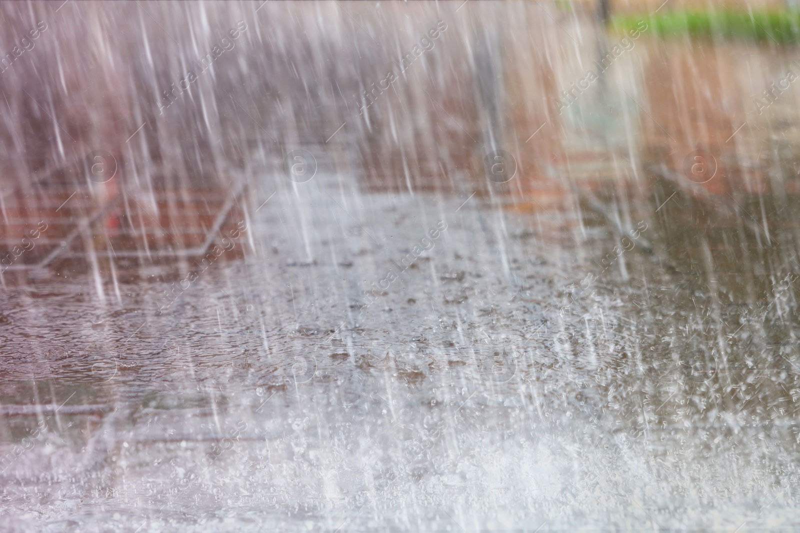 Image of View of city street with puddles on rainy day, closeup