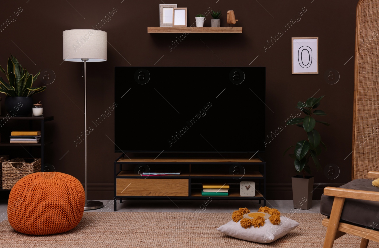 Photo of Modern TV on cabinet, stylish furniture and decorative elements in room. Interior design