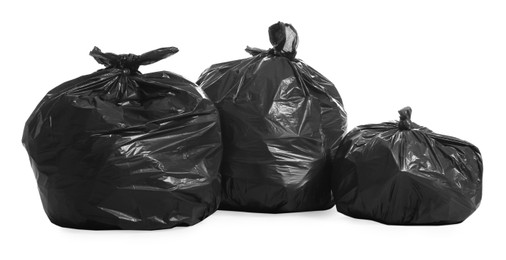 Black trash bags full of garbage on white background