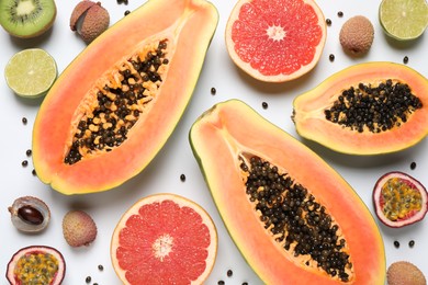 Photo of Fresh ripe papaya and other fruits on white background, top view