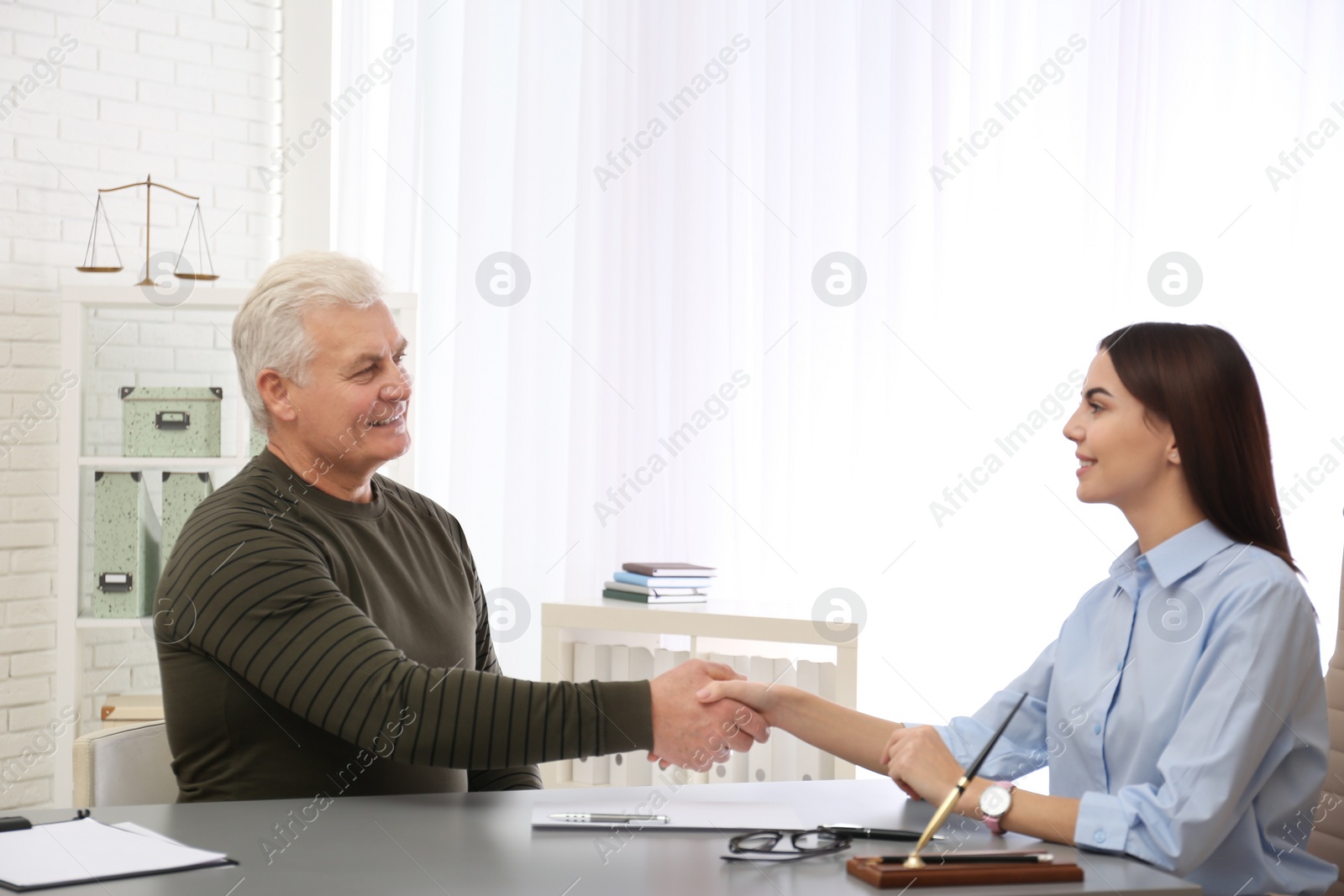 Photo of Lawyer having meeting with client in office