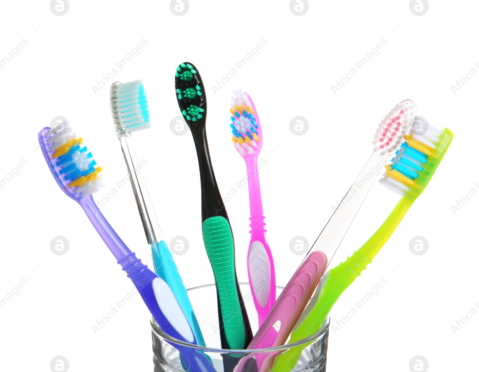 Photo of Cup with different toothbrushes on white background. Dental care