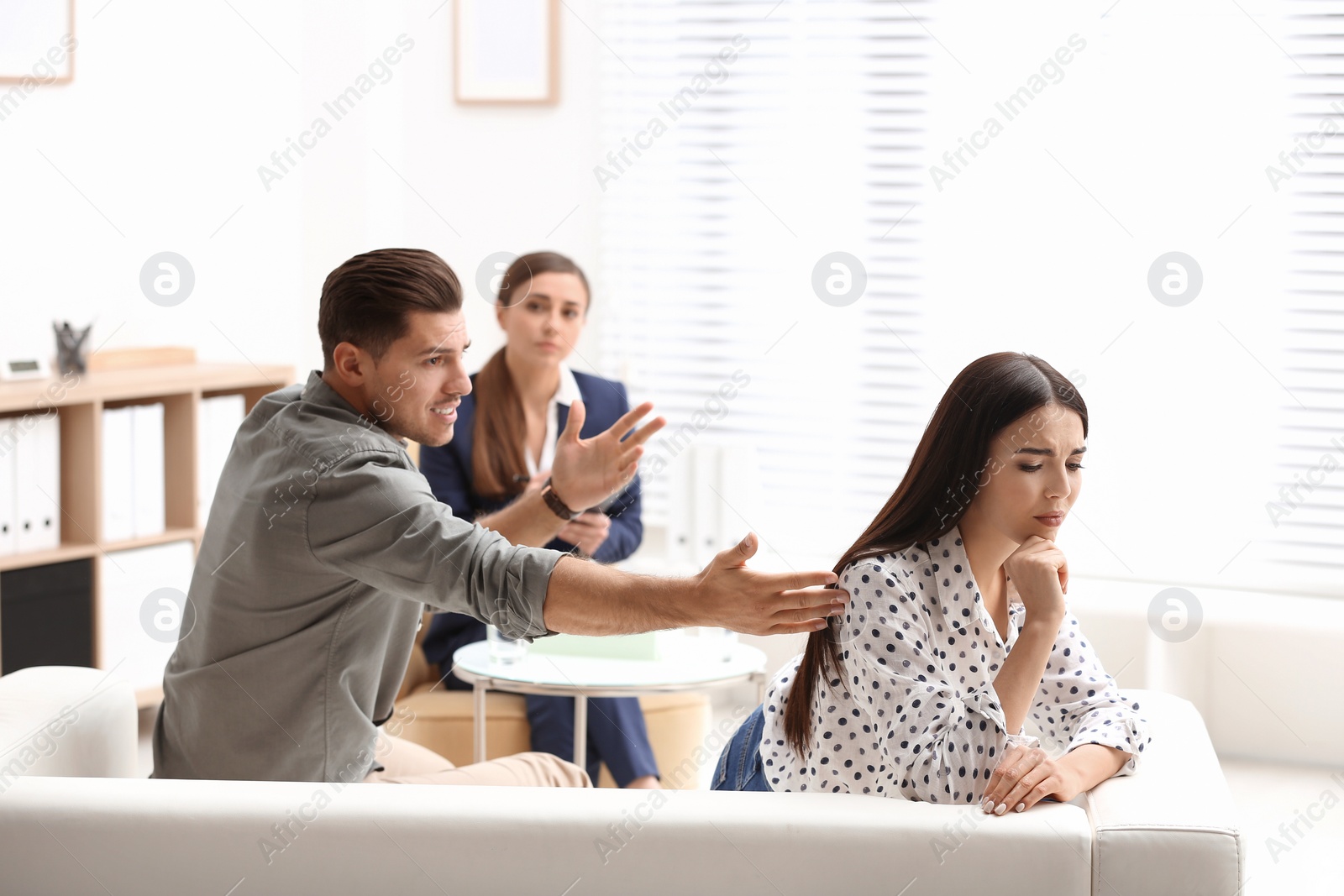 Photo of Professional psychologist working with couple in office