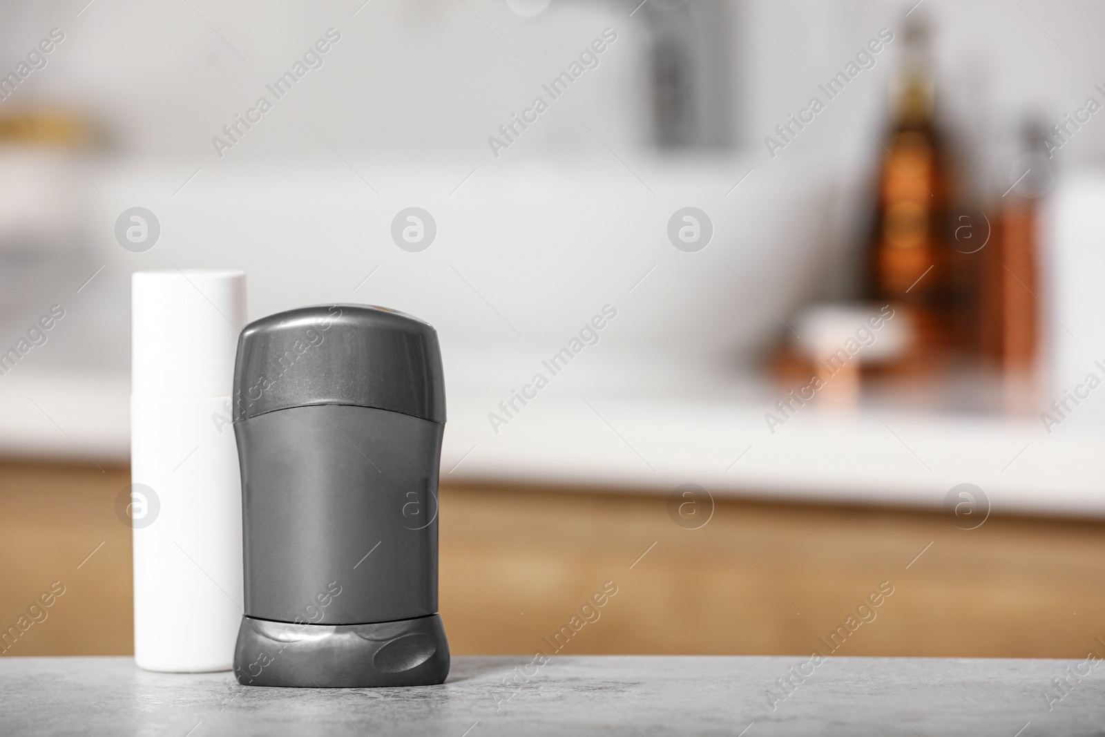 Photo of Different deodorants on table in bathroom, space for text