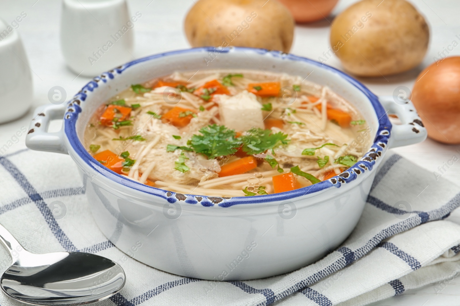 Photo of Dish with fresh homemade chicken soup served on table