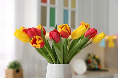 Photo of Easter celebration. Bouquet of beautiful tulips on blurred background, closeup